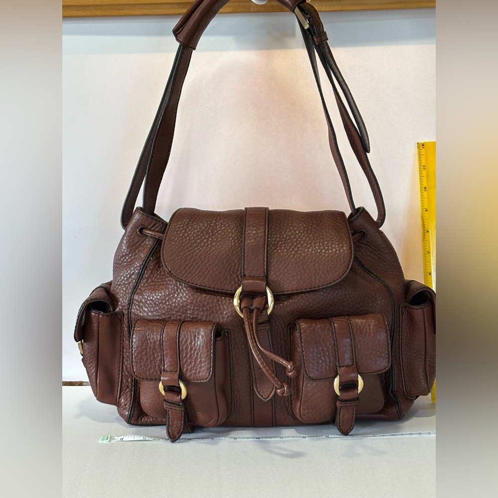 COLE HAAN-Pebbled Leather with adjustable straps and many pockets.